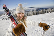 Young woman holding ski and pole, portrait
