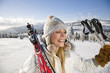 Young woman holding ski pole