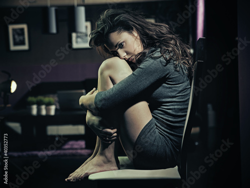Photo: Sad woman sitting on a chair Sad woman sitting on a chair