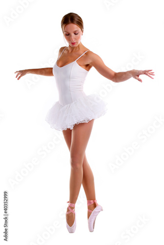 Photo: Portrait of ballerina dancing on pointes over white Portrait of ballerina dancing on pointes over white