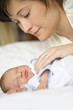 Mother with baby on bed, close-up