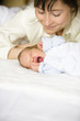 Mother looking at yawning baby