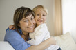 Mother embracing daughter, smiling, portrait