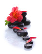 Spa stones with drops, red flower and petals isolated on white