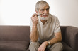 Senior man holding smoke pipe, portrait