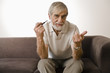 Senior man holding smoke pipe, portrait