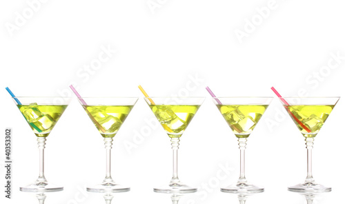 Photo: Yellow cocktail in martini glasses isolated on white Yellow cocktail in martini glasses isolated on white
