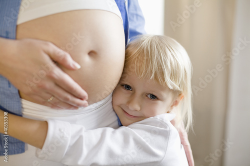 Photo: Girl embracing woman, smiling, portrait Girl embracing woman, smiling, portrait