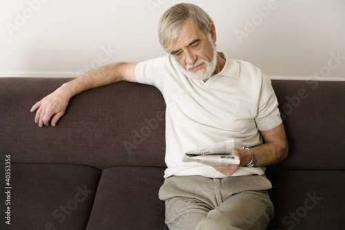 Photo: Senior man reading newspaper Senior man reading newspaper