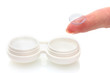 contact lens on finger and case isolated on white