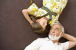 Senior man and girl resting on sofa