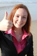 Thumbs up! - beautiful woman at the beach gesturing thumbs up