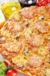 Italian cuisine. Pizza with salami, pickles and olives