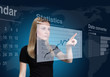 Photo: Pretty blonde drawing chart on virtual touch screen Pretty blonde drawing chart on virtual touch screen