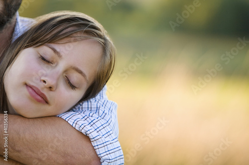 Photo: Mid adult couple embracing, portrait Mid adult couple embracing, portrait