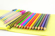 Color pen and pencils on the yellow writing-book Color pen and pencils on the yellow writing-book