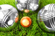 The bocce balls on a green grass.