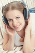 beautiful smiling girl enjoys listening to music on headphones o