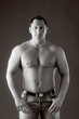 Photo: Adult muscular man, on the grey background Adult muscular man, on the grey background