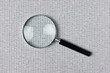 magnifying glass on a binary code