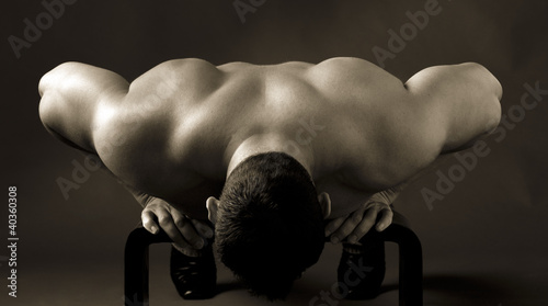 Photo: Adult muscular man, on the grey background Adult muscular man, on the grey background