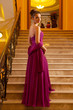 woman in a long dress lying on the stairs