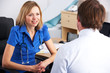 Female UK doctor talking to male patient