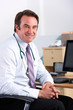 Portrait UK doctor sitting at desk