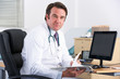 Portrait UK doctor sitting at desk