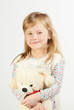 Little girl with a teddy bear on a white background Little girl with a teddy bear on a white background