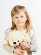 Little girl with a teddy bear on a white background Little girl with a teddy bear on a white background