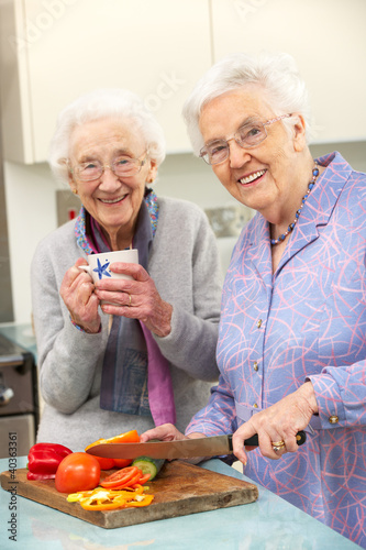 Photo: Senior women preparing meal together Senior women preparing meal together