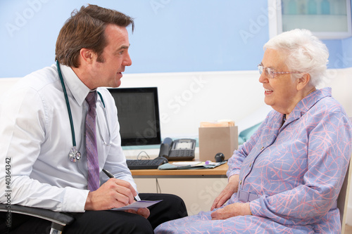 Photo: UK GP talking to senior woman patient UK GP talking to senior woman patient