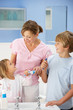 Mother and children cleaning teeth in bathroom