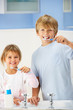 Boy and girl cleaning teeth in bathroom