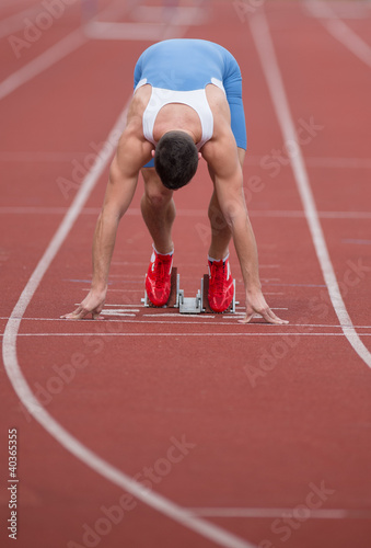 Photo: Sprinter in the starting blocks, ready to go Sprinter in the starting blocks, ready to go