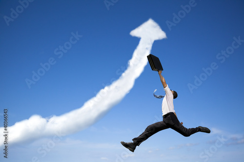 Photo: jumping businessman with business growing graph cloud jumping businessman with business growing graph cloud