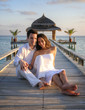 Sensual happy lovers in white clothes on the beach (Maldives)