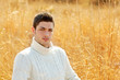 Autumn winter man portrait in outdoor dried grass