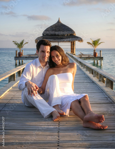 Photo: Sensual happy lovers in white clothes on the beach (Maldives) Sensual happy lovers in white clothes on the beach (Maldives)