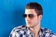 handsome man with plaid shirt and sunglasses handsome man with plaid shirt and sunglasses