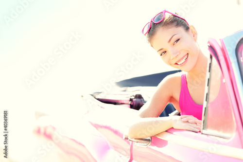 Photo: Happy free woman driving convertible car on road trip Happy free woman driving convertible car on road trip