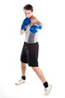young boxer in gray shirt and blue boxing gloves