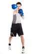 young boxer in gray shirt and blue boxing gloves