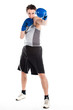 young boxer in gray shirt and blue boxing gloves