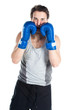 young boxer in gray shirt and blue boxing gloves