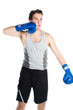 young boxer in gray shirt and blue boxing gloves