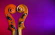 Photo: Two vintage violin scrolls make heart shape with copy-space Two vintage violin scrolls make heart shape with copy-space