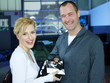 Pretty customer gets service book from master mechanic
