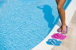 Female legs with colorful slippers